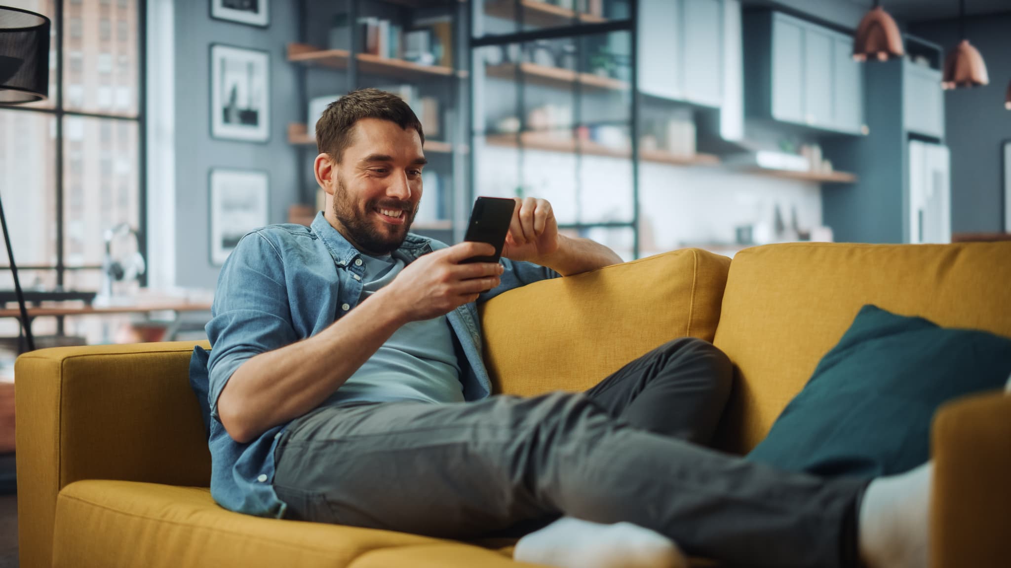 A happy man looking at his phone